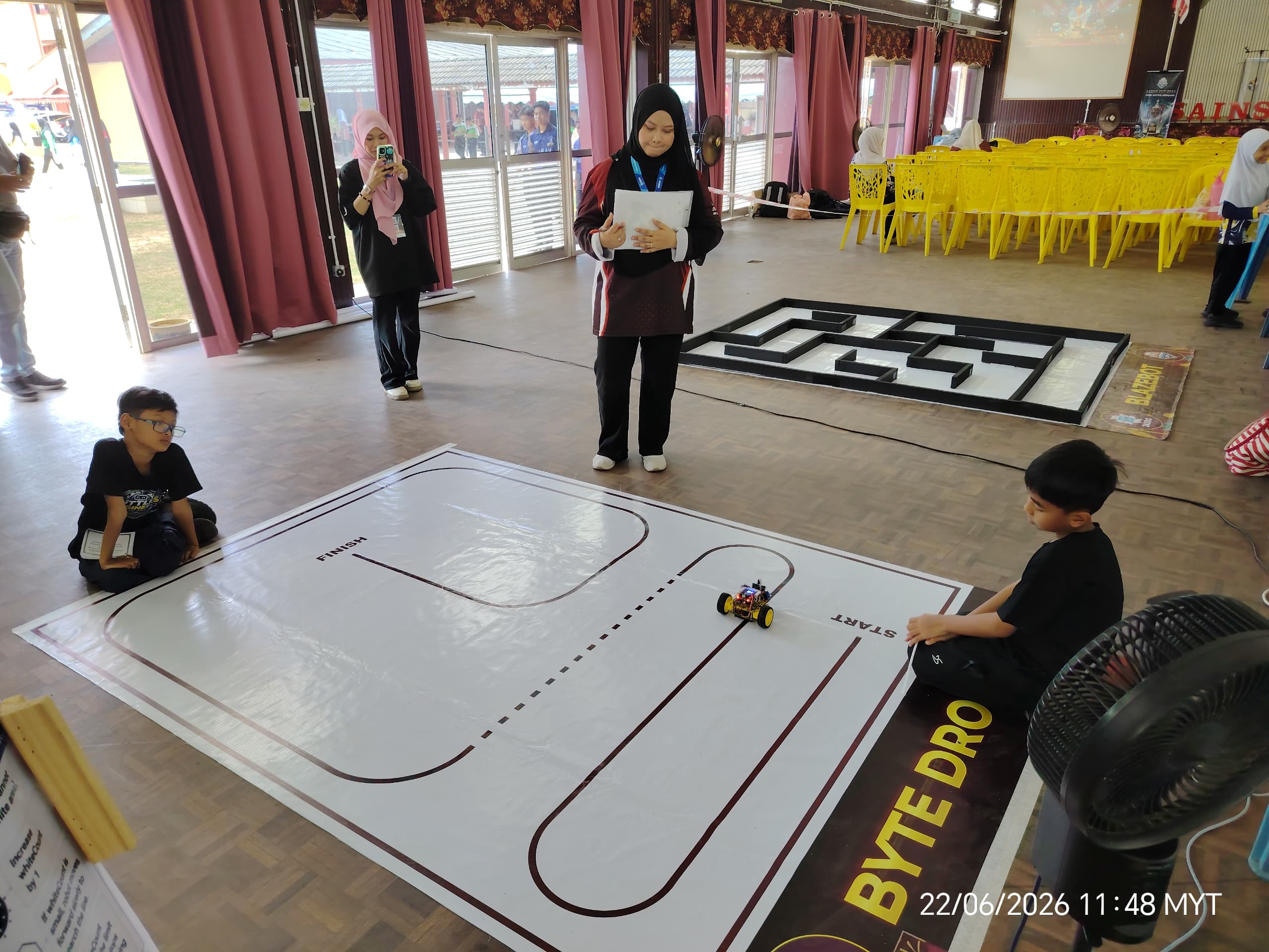 Team observing robot movement on the track